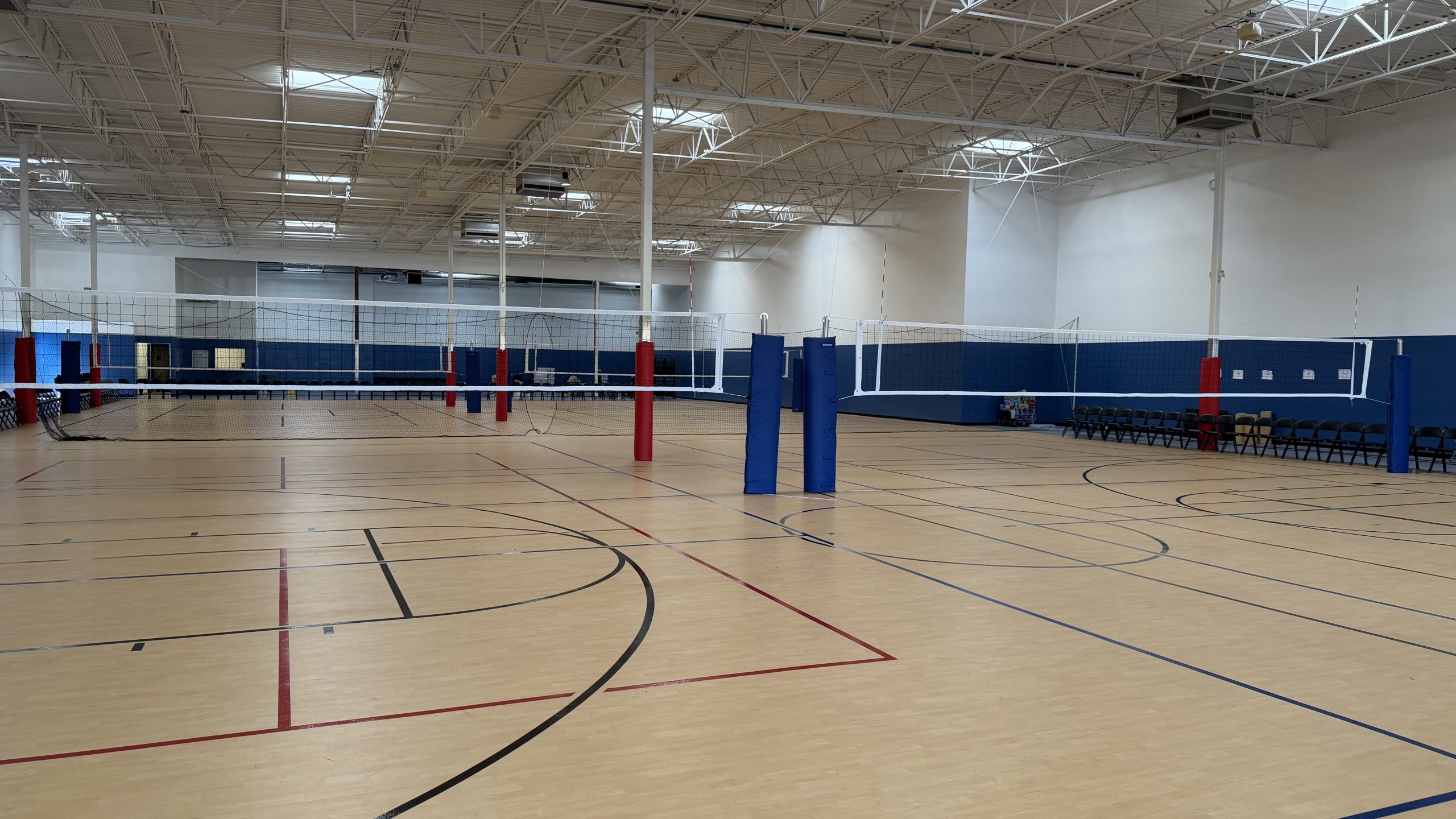 Blitz Sports Center gym set up with volleyball nets on professional Gerflor sports flooring